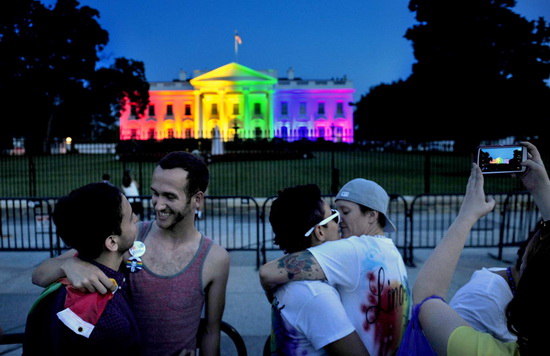 WASHINGTON, DC- JUNE 26: With at colorful White House backdrop, (L) Kevin Barragan and his partner Adam Smith celebrate the decision today as do Kelly Miller (with glasses) and her wife Lindsey Miller. The Miller's were married 2 years ago in Washington State where gay marriage was legal.The White House was lit in multi-colored lights tonight to honor the Supreme Court decision to allow gay marriage. Michael S. Williamson/The Washington Post via Getty Images)